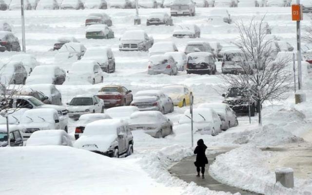 A woman walks back to her car in the long term parking lot at Indianapolis International Airport