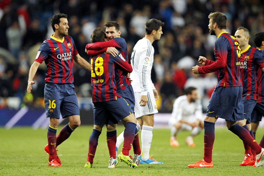 Barcelona's Lionel Messi from Argentina (third left) and team mates celebrates their victory during a Spanish La Liga soccer match between Real Madrid and FC Barcelona at the Santiago Bernabeu stadium in Madrid, Spain on Sunday.