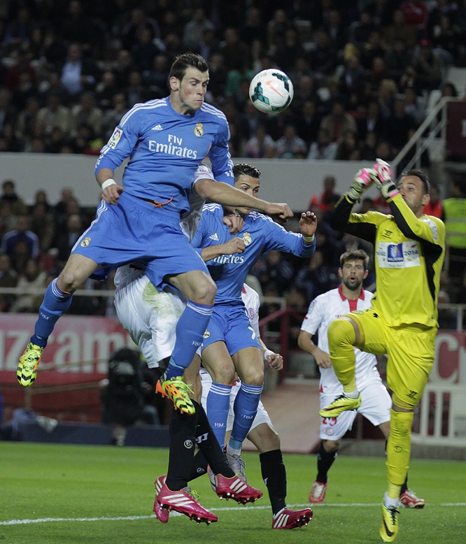 Real Madrid's Gareth Bale from Wales (top) jumps for the ball against Sevilla during their La Liga soccer match at the Ramon Sanchez Pizjuan stadium in Seville, Spain on Wednesday.