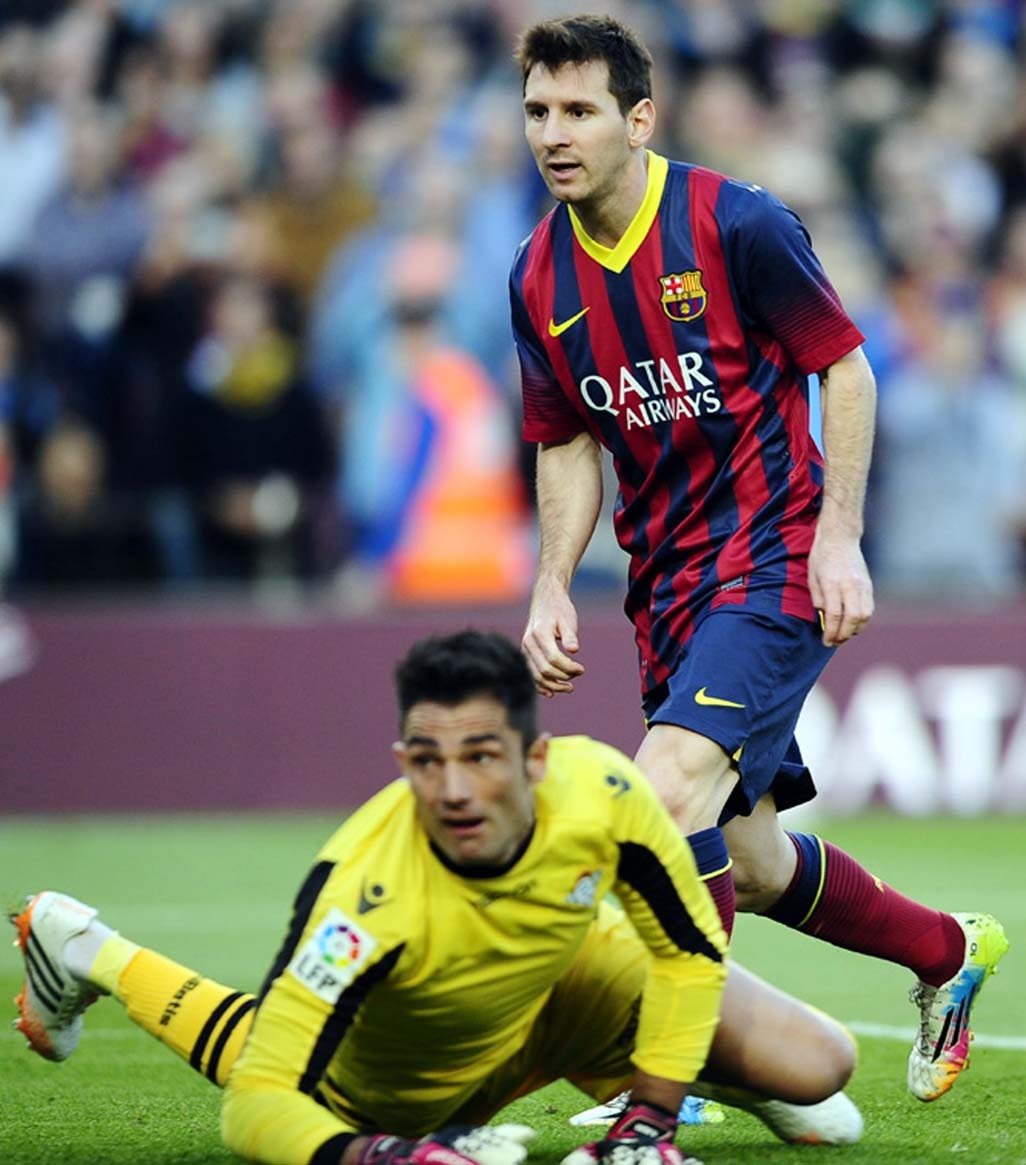 FC Barcelona's Lionel Messi, from Argentina (right) scores against Betis's Antonio Adan during a Spanish La Liga soccer match against Betis at the Camp Nou stadium in Barcelona Spain on Saturday.