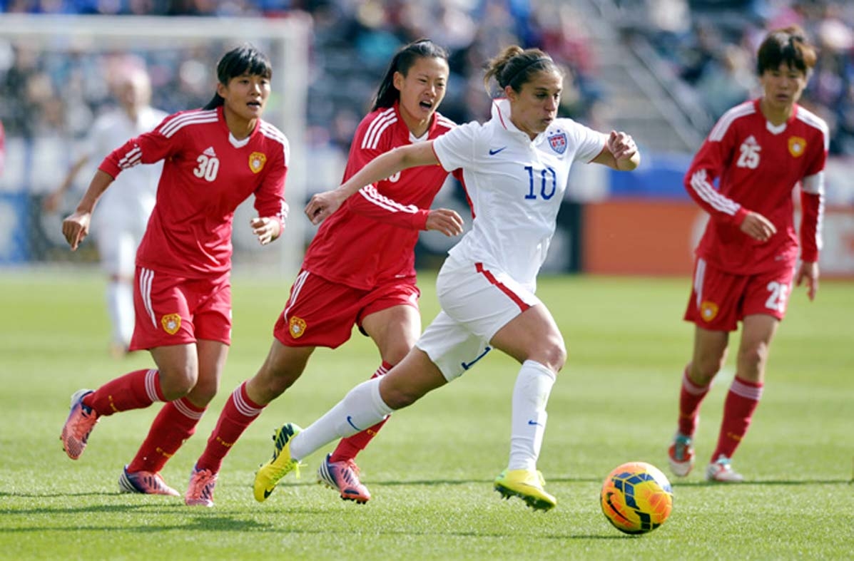 US midfielder Carli Lloyd (10) moves the ball upfield against China's Lui Shanshan (30), Zhang Xin and Zhang Rui (25) during the second half of an international friendly soccer match in Commerce City, Colo on Sunday. The United States won 2-0.