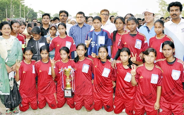Members of Rangpur District team, the champions of the final match of Dinajpur Venue of the KFC National Women's Football Championship with the chief guest Additional Police Super of Dinajpur Sanjay Sarkar pose for a photograph at the Dinajpur Bara Maida