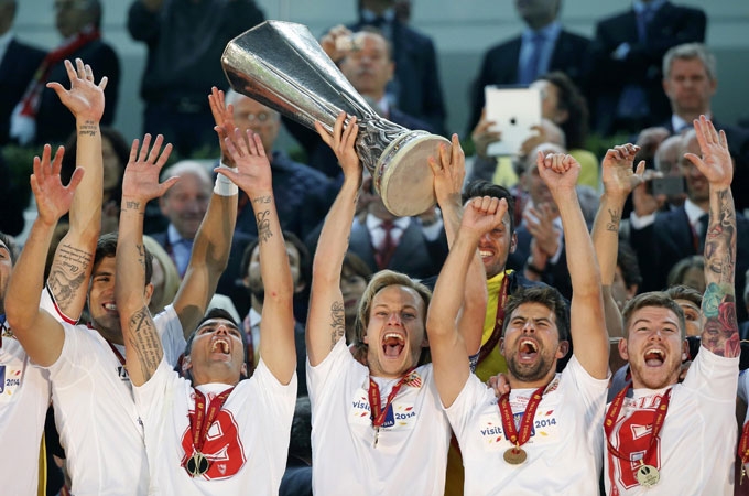 Sevilla players celebrate with the trophy after the Europa League soccer final between Sevilla and Benfica at the Turin Juventus stadium in Turin, Italy on Thursday. Sevilla beat Benfica 4-2 on penalties to win Europa League final. Sevilla secured their t