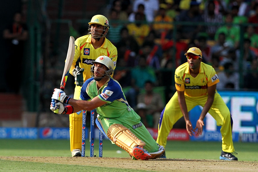 Yuvraj Singh loses his balance but still hits this slog-sweep out of the middle during IPL 2014 between Royal Challengers Bangalore and Chennai Super Kings at Bangalore on Saturday.