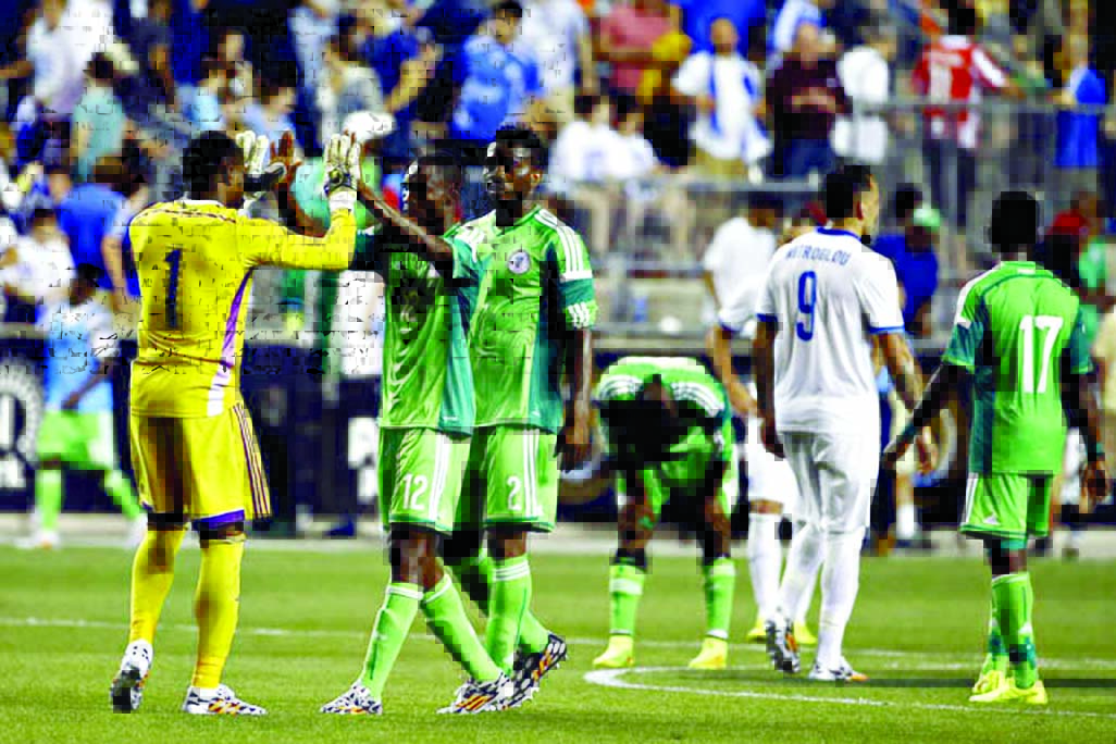 Nigeria's Vincent Enyeama (1) and Kunle Odunlami (12) meet after an international friendly soccer match against Greece on Tuesday in Chester Pa. The match ended in a tie, 0-0.