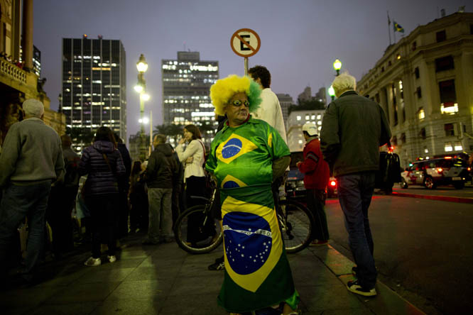 A man dressed in an outfit with Brazilian flags motifs stands on downtown corner in Sao Paulo, Brazil on Tuesday. The 2014 World Cup is set to begin Thursday, with Brazil and Croatia competing in the opening match in Sao Paulo.