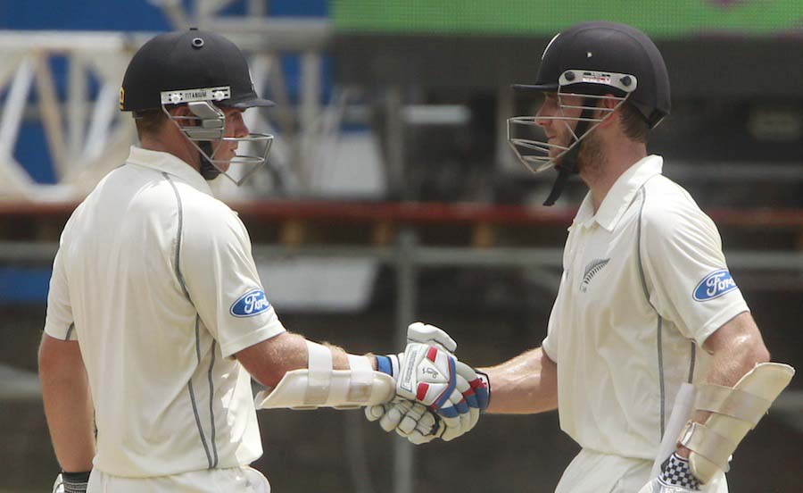 After scoring a half century, New Zealand's opening batsman Tom Latham (left) is congratulated by batting partner Kane Williamson, with a handshake during the opening day of the second cricket Test match against west Indies in Port of Spain, Trinidad on