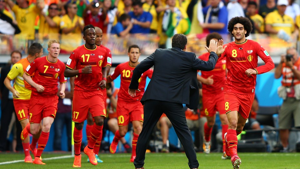 Marouane Fellaini of Belgium (C) celebrates scoring his team's first goal with head coach Marc Wilmots during the 2014 FIFA World Cup Brazil Group H match between Belgium and Algeria at Estadio Mineirao on Tuesday in Belo Horizonte, Brazil.