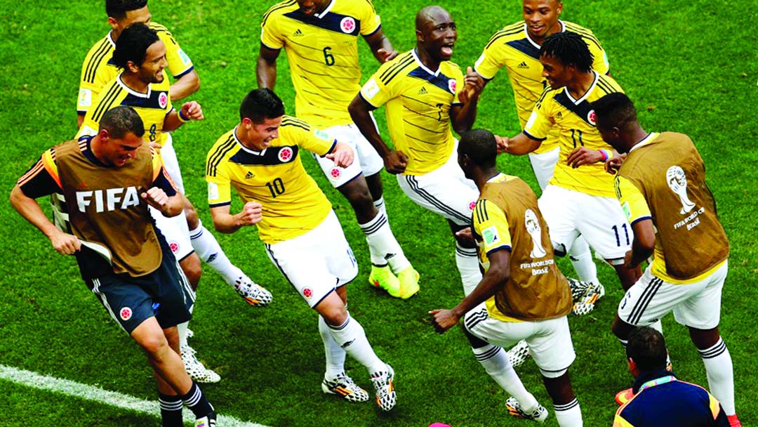 James Rodriguez (10) of Colombia celebrates by dancing with teammates after scoring his team's first goal during the 2014 FIFA World Cup Brazil Group C match between Colombia and Ivory Coast at Estadio Nacional in Brasilia, Brazil on Thursday.