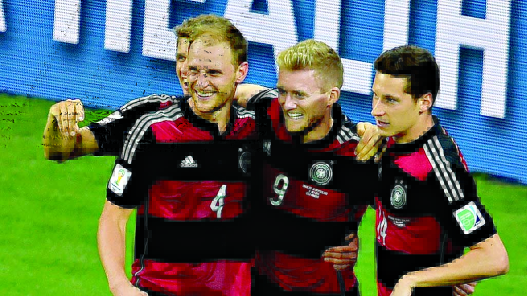 Germany's forward Andre Schuerrle celebrates with Germany's defender Benedikt Hoewedes and Germany's midfielder Julian Draxler after scoring his second goal, Germany's seventh during the semi-final football match of 2014 FIFA World Cup between Brazil