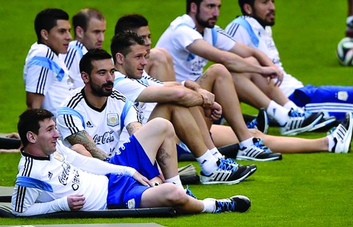 Argentina's forward Lionel Messi (L) gestures next to teammates during a training session at "Cidade do Galo", their base camp in Vespasiano near Belo Horizonte, some 470 Km north of Rio de Janeiro, Brazil on Thursday ahead the 2014 FIFA World Cup fina