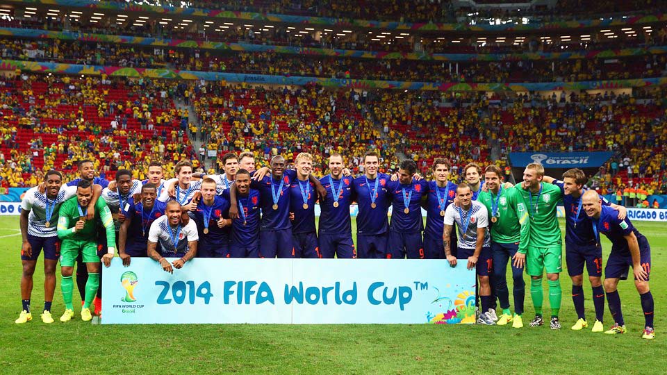 The players of Netherlands celebrate with their medals after defeating Brazil 3-0 in the 2014 FIFA World Cup Brazil third place play-off match between Brazil and the Netherlands at Estadio Nacional in Brasilia, Brazil on Saturday.