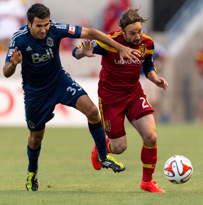 Vancouver's Steven Beitashour (33) and Real Salt Lake's Ned Grabavoy (20) battle for the ball as Real Salt Lake hosts Vancouver Whitecaps FC at Rio Tinto Stadium in Sandy, Utah on Saturday.
