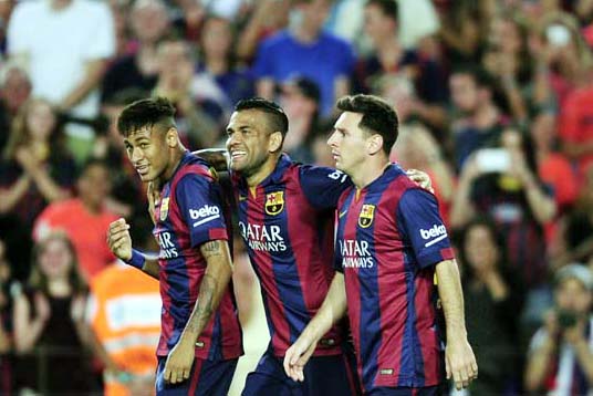 Barcelona's Lionel Messi from Argentina (right) reacts after scoring with his teammates Neymar from Brazil (left) and Dani Alves against Leon during the Joan Gamper trophy friendly soccer match at the Camp Nou in Barcelona, Spain on Monday.