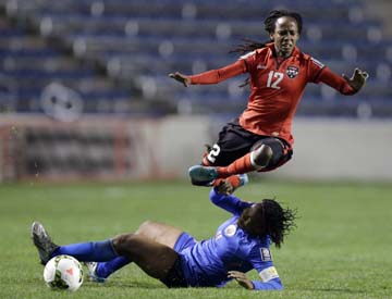 Trinidad and Tobago's Ahkeela Mollon (12) (top) is tackled by Haiti's Kencia Marseille, bottom during the second half of a CONCACAF Women's Championship soccer game on Friday in Bridgeview, Ill. Trinidad and Tobago won 1-0.