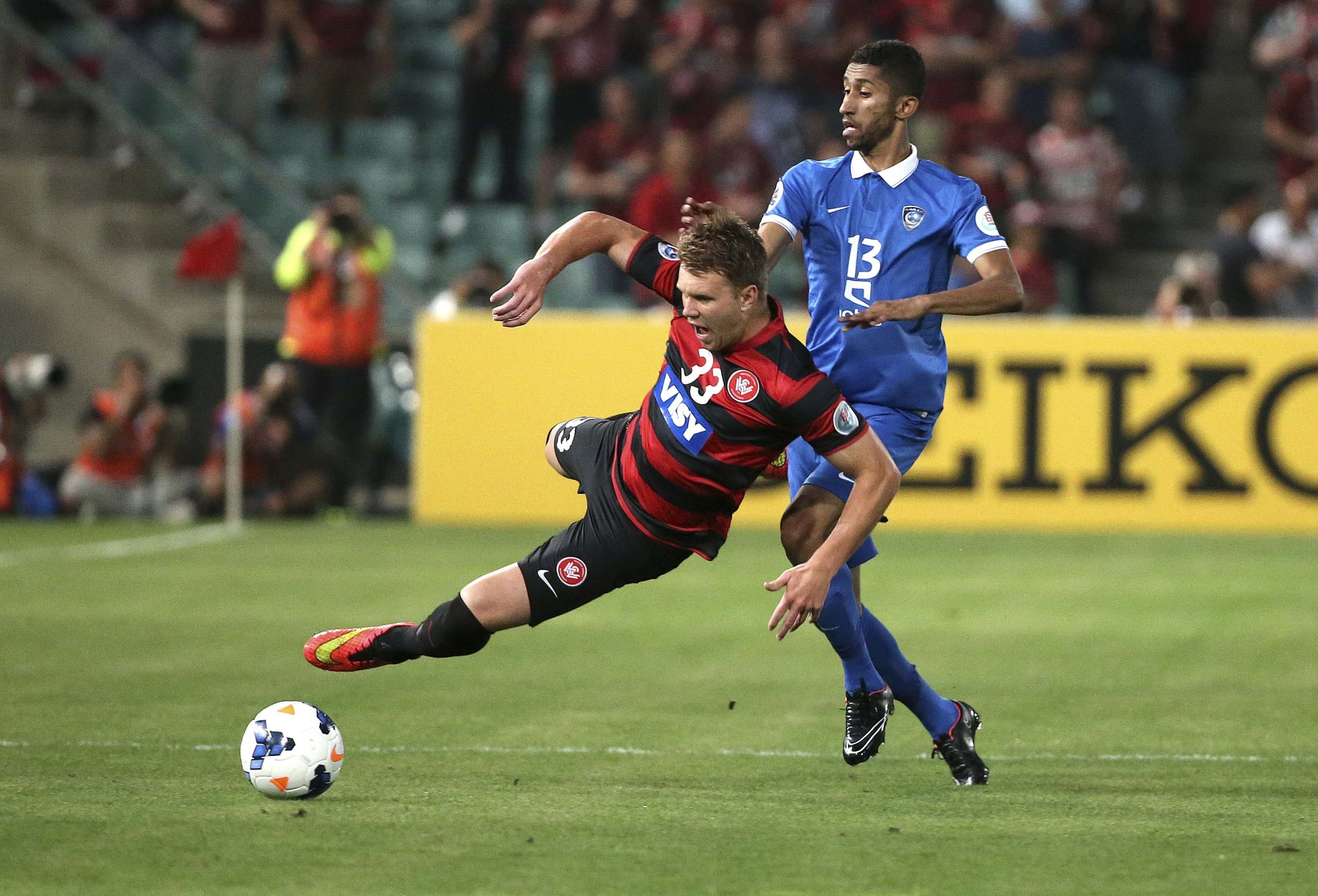 Western Sydney Wanderers' Daniel Mullen (left) is tackled by Saudi Arabia's Al Hilal's Salman Al-Faraj during their Asian Champions League Final soccer match in Sydney, Australia on Saturday.