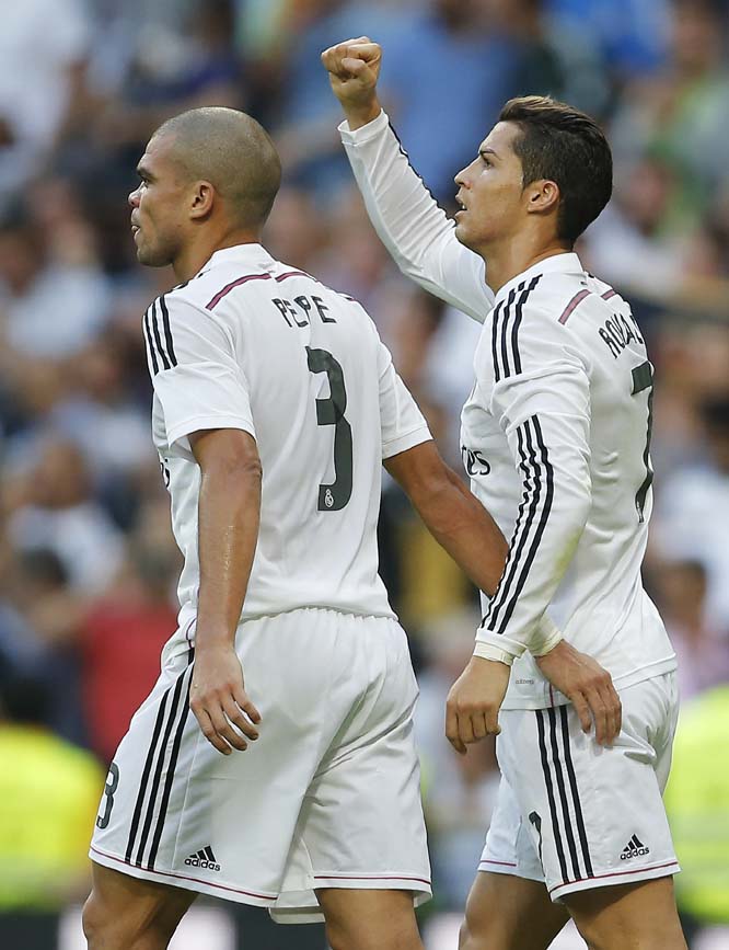 Real Madrid's Cristiano Ronaldo (right) celebrates his goal with teammate Pepe during a Spanish La Liga soccer match between Real Madrid and FC Barcelona at the Santiago Bernabeu stadium in Madrid, Spain on Saturday.