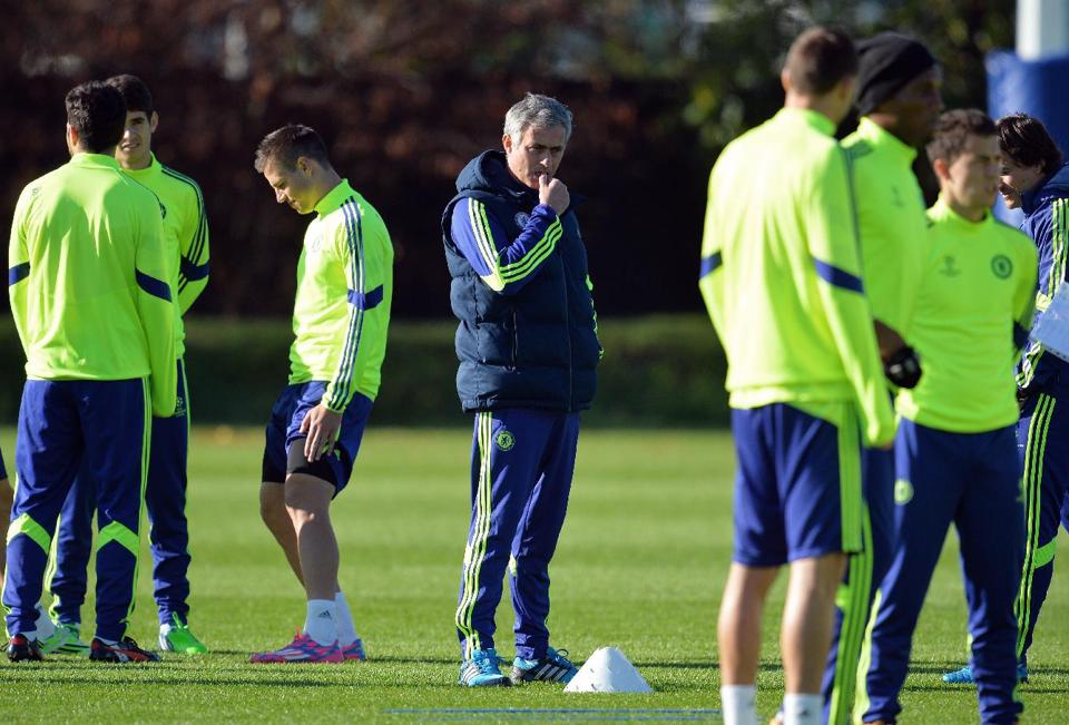 Chelsea's Portuguese manager Jose Mourinho (C) takes part in a training session at their training ground in Cobham, south of London recently.