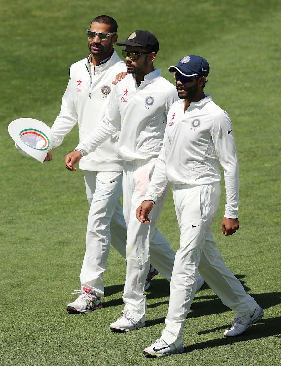 Shikhar Dhawan, Virat Kohli and Ravindra Jadeja walk off the field on the 1st day of the tour match between Cricket Australia XI and India at Gliderol Stadium in Adelaide, Australia on Monday.