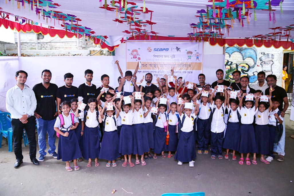 ServicEngineBPO, a leading outsourcing company, distributes milk among underprivileged children at JAAGO Foundation School, Rayer Bazar Branch in the capital as a part of its CSR programme on Monday.